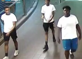 The trio is seen after the attack inside the Roosevelt Avenue F train station.