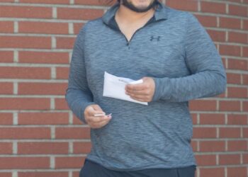 Edwin Castro photographed after withdrawing an envelope of cash from his local bank.