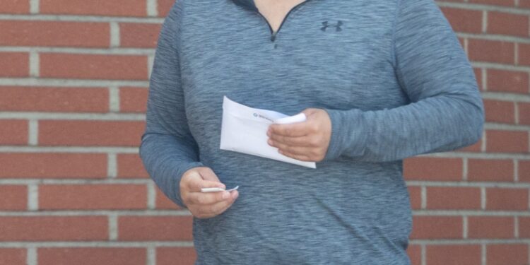 Edwin Castro photographed after withdrawing an envelope of cash from his local bank.