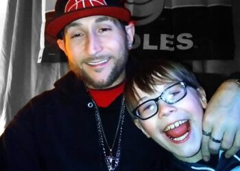 Christopher Wright with one of his sons. He died while preventing a group of people from fighting his 14-year-old son.