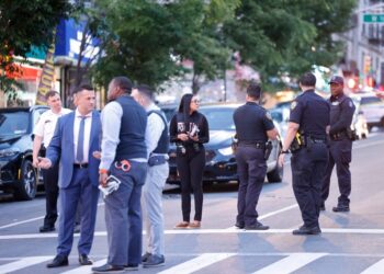 Officers and detectives investigate at the scene of the deadly shooting at West 162nd Street and Broadway in Washington Heights.