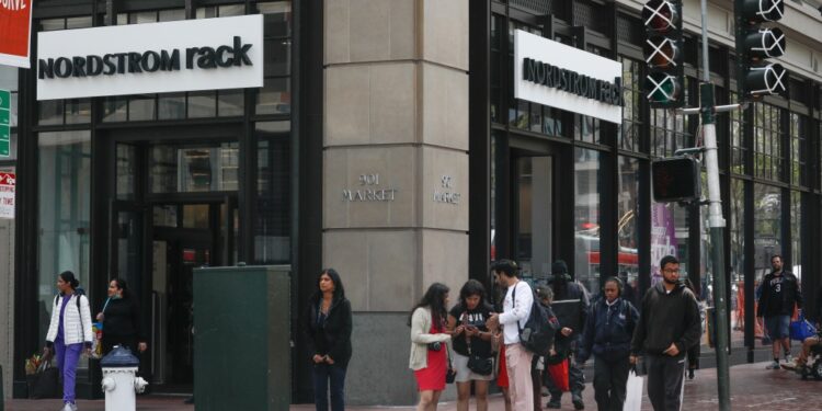 Pedestrians cross 5th Street at Market Street next to the Nordstrom Rack on Tuesday, May 2, 2023 in San Francisco, Calif