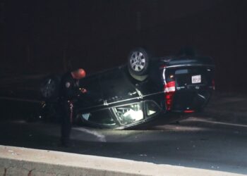The flipped-over Hyundai Sonata seen on the side of the Bruckner Expressway.