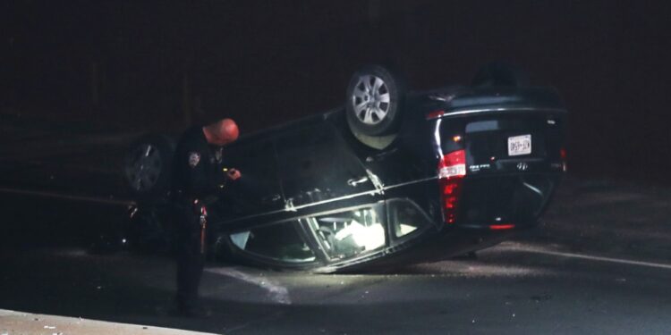 The flipped-over Hyundai Sonata seen on the side of the Bruckner Expressway.