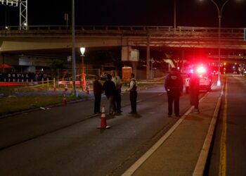 Police respond to the scene where three men were shot at  Beach 95th Street near Beach Channel Drive in Rockaway Beach.