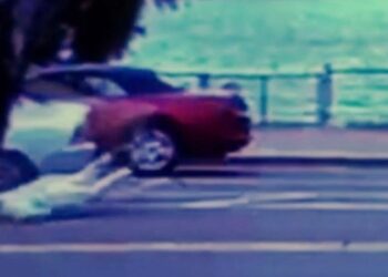 Woman falls after being dragged by the car