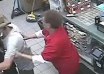 Moment clerk touches thief stealing cigarettes.