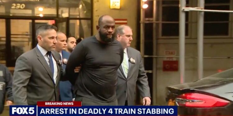 Claude White is led out of court in handcuffs by detectives.