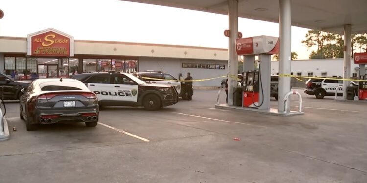 Police tape and police car outside of Houston gas station