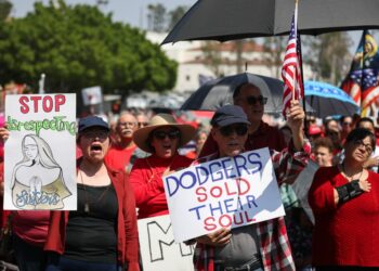Protesters hold signs at a Catholics for Catholics event in response to the Dodgers' Pride Night event including the Sisters of Perpetual Indulgence prior to the game between the San Francisco Giants and the Los Angeles Dodgers at Dodger Stadium on June 16, 2023 in Los Angeles, California.