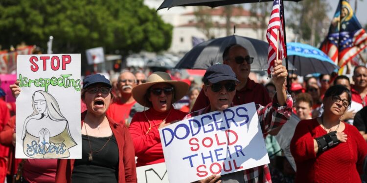 Protesters hold signs at a Catholics for Catholics event in response to the Dodgers' Pride Night event including the Sisters of Perpetual Indulgence prior to the game between the San Francisco Giants and the Los Angeles Dodgers at Dodger Stadium on June 16, 2023 in Los Angeles, California.
