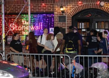 Police are seen in front of the Stonewall Inn where a person was slashed Monday, June 26, 2023.