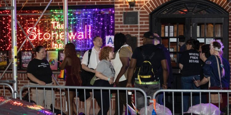 Police are seen in front of the Stonewall Inn where a person was slashed Monday, June 26, 2023.