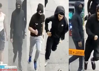 The robbery crew, most of them wearing hoodies, are seen running off.