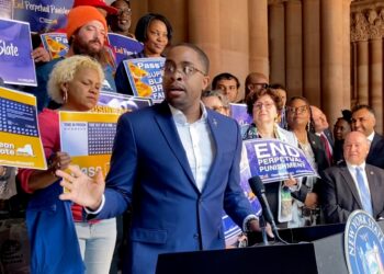 Zellnor Myrie gesturing at a NYS Capitol rally for the clean slate bill with lots of people standing behind him