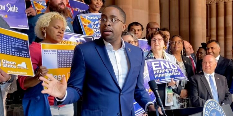 Zellnor Myrie gesturing at a NYS Capitol rally for the clean slate bill with lots of people standing behind him