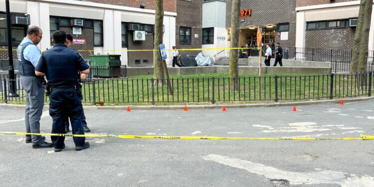 Police gather outside of NYCHA's Polo Grounds Towers.