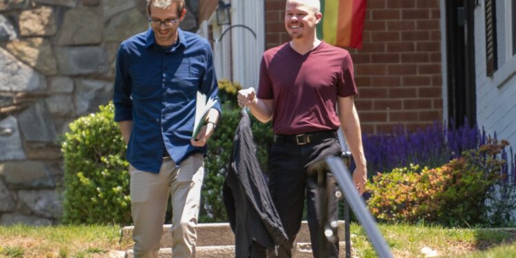 Samuel Brinton, 34, right, and his husband, Kevin Rieck, photographed outside their home in Rockville, Maryland on Friday, June 2, 2023.