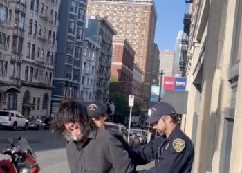 man on street getting handcuffed