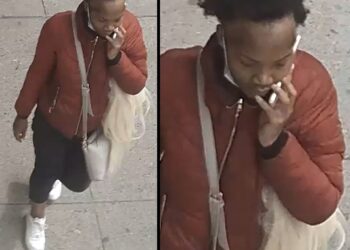 The suspect in the stabbing at Tillary and Jay streets is shown walking on the sidewalk while on the phone.