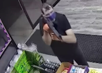 Surveillance footage of a man armed with a rifle robbing Veterans Convenience store in Staten Island on July 8, 2023.