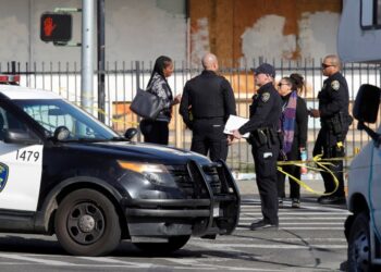 OAKLAND, CALIFORNIA - FEBRUARY 17:: Oakland police investigate the scene after shooting an armed carjacking suspect on International Boulevard and 105th Avenue in East Oakland, Calif., on Friday, Feb. 17, 2023. The condition of the man shot was not immediately available and he was transported to a local hospital.