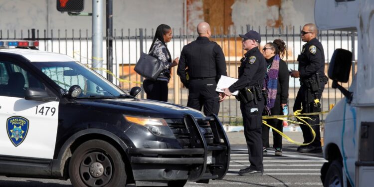 OAKLAND, CALIFORNIA - FEBRUARY 17:: Oakland police investigate the scene after shooting an armed carjacking suspect on International Boulevard and 105th Avenue in East Oakland, Calif., on Friday, Feb. 17, 2023. The condition of the man shot was not immediately available and he was transported to a local hospital.