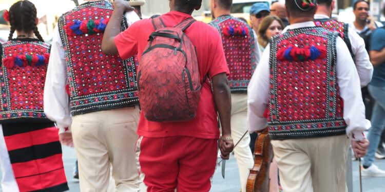Eagle-eyed NYC photographer captures shocking moment knife-wielding man creeps up behind group in Times Square