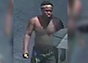 A surveillance photo of Anthony Kwamel, 21, seen shirtless as he crossed the street after the attack.