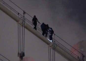 Two people were taken into custody for climbing on the Manhattan Bridge Saturday night.