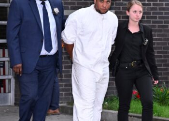 Thomas Abreu being walked out of the 107th Precinct.