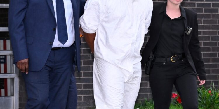 Thomas Abreu being walked out of the 107th Precinct.