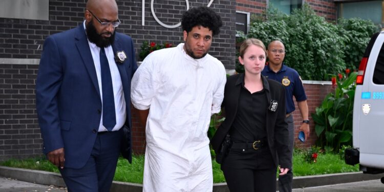 Police walking Abreu out of the 107th Precinct.