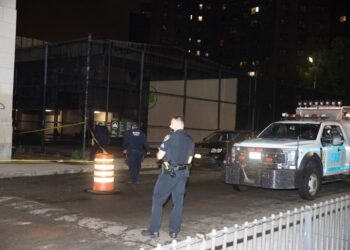Police are seen at the scene of a woman shot in the shoulder in front of 78 Catherine St. in Manhattan.