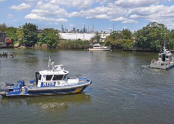 An NYPD boat trolls Newtown Creek