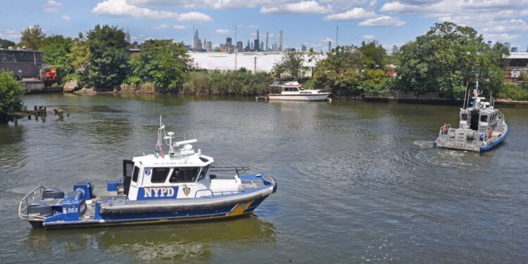An NYPD boat trolls Newtown Creek
