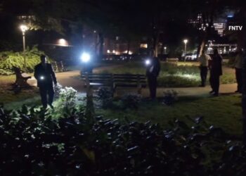 Detectives investigate the scene where a female panhandler was raped in a church courtyard in Chelsea.