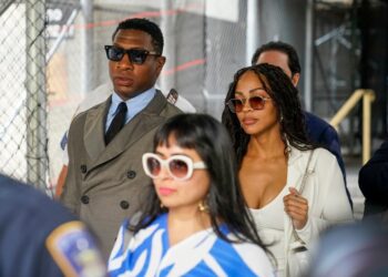 Jonathan Majors and his girlfriend, Meagan Good, leave court Thursday morning.