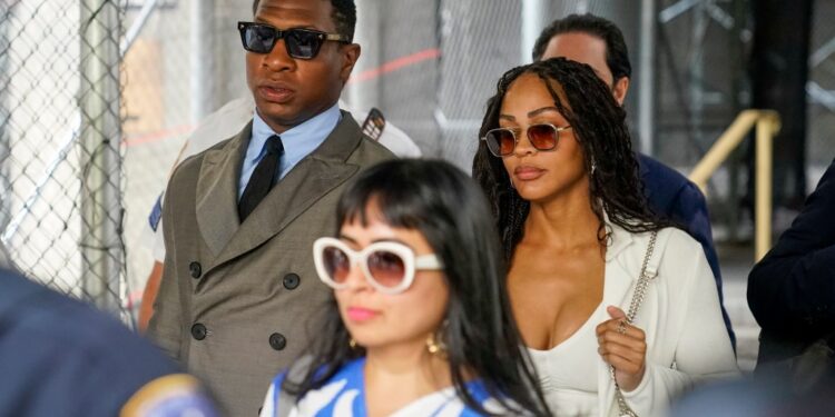 Jonathan Majors and his girlfriend, Meagan Good, leave court Thursday morning.