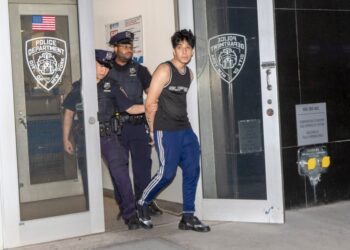 Kyle Fernandez in handcuffs