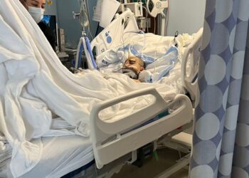 An image released by family shows the young victim in a hospital bed, with an apparent neck brace.