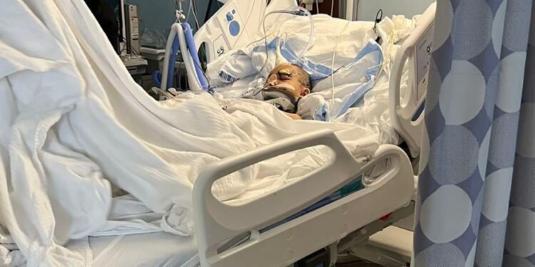 An image released by family shows the young victim in a hospital bed, with an apparent neck brace.