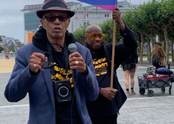 Del Seymour, nicknamed the Mayor of the Tenderloin District, talks to tour participants of the  Celebrate Tenderloin Tour outside of San Francisco City Hall on Saturday.