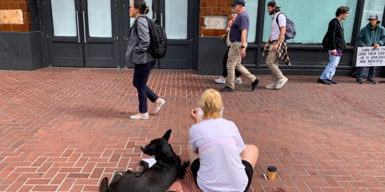 A homeless lady is shown begging on Market Street of San Francisco, California on Thursday, August 17, 2023. The Mayors office has faced a lot of criticism related to crime and homeless issues in the city.
