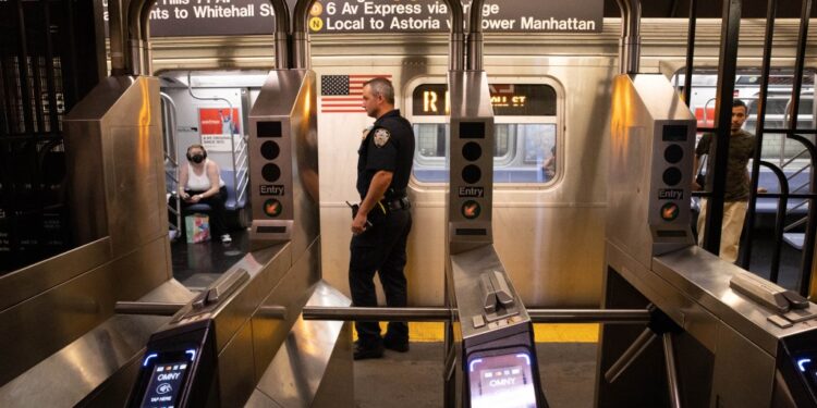 Police are seen at the scene of a stabbing in transit at 24th St. and 4th Ave. in Brooklyn,
