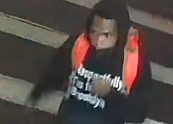pictured is a suspected shooter wearing a black hoodie emblazoned with the words, "Respectfully I'm from Brooklyn."