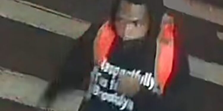 pictured is a suspected shooter wearing a black hoodie emblazoned with the words, "Respectfully I'm from Brooklyn."