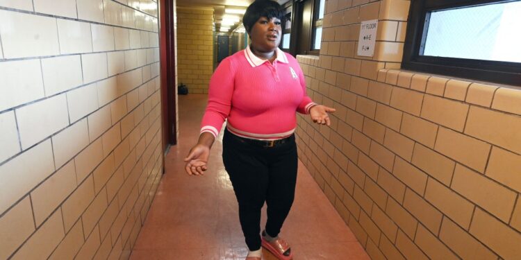 Shaquana Applewhite stands exasperated in her hallway in the Bushwick Houses.