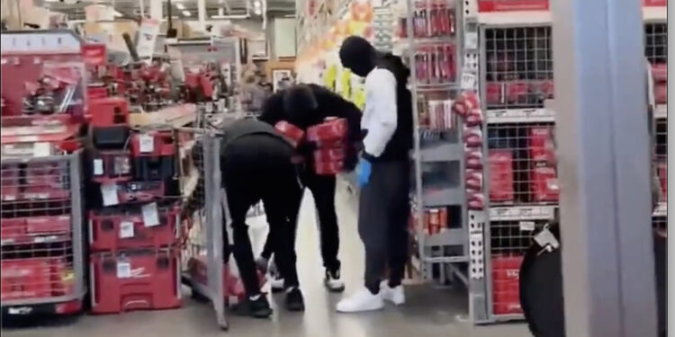 Three of the thieves loading up on power tools on Home Depot.