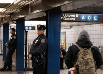 Officers patrol inside an A and C subway station in Manhattan.